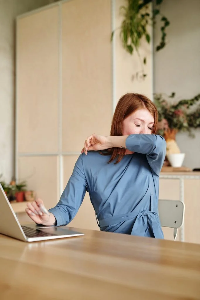 a sick woman covering her mouth